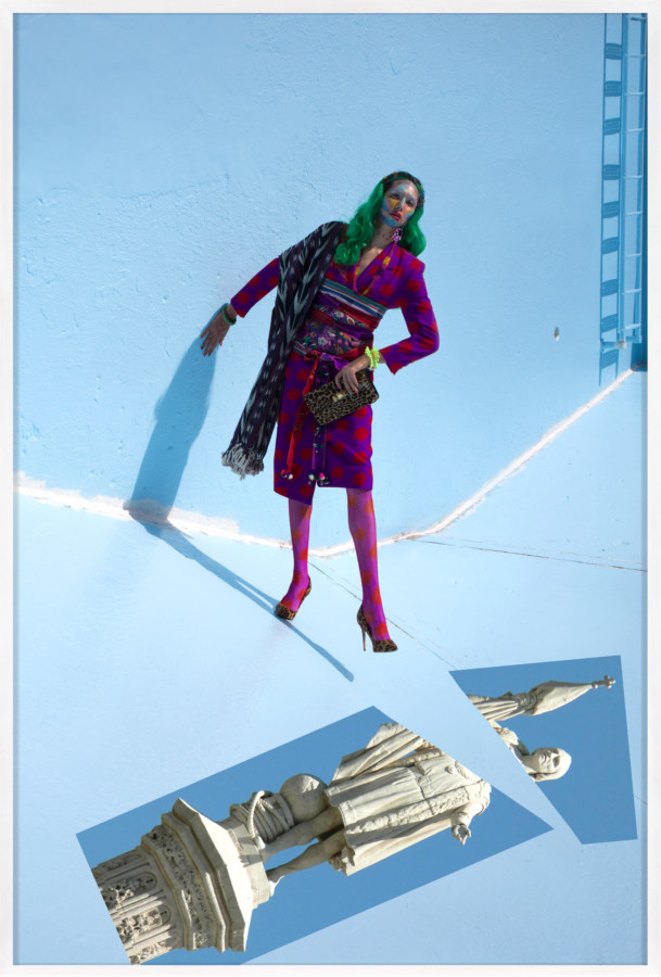 Framed color photograph of a woman with green hair and magenta outfit on a light blue background with a statue's image cut in two pieces below