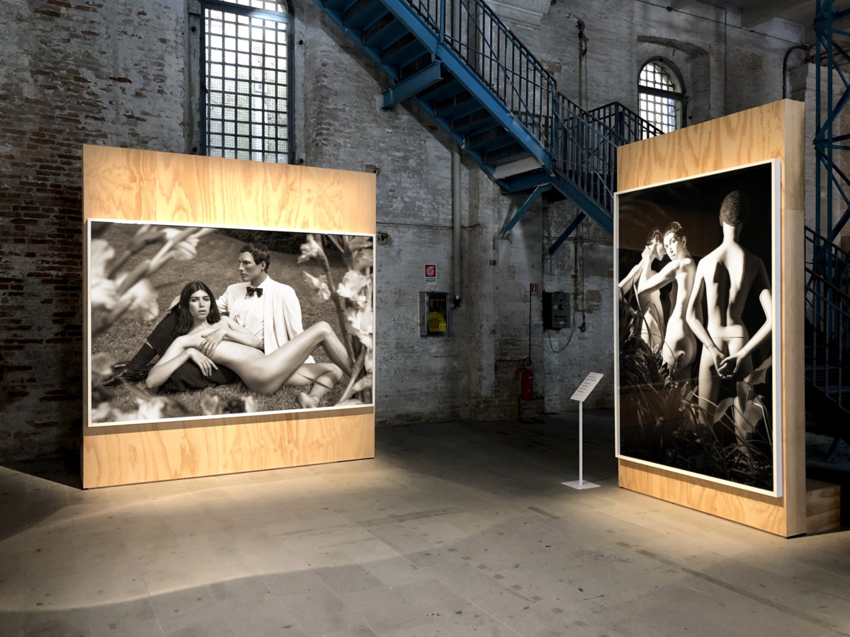 Color image of large scale black and white photographs exhibited in industrial space