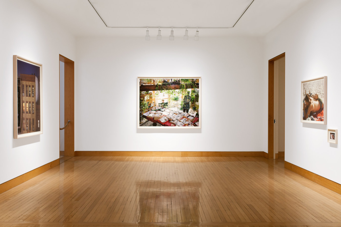 Color image of color photographs on white gallery walls