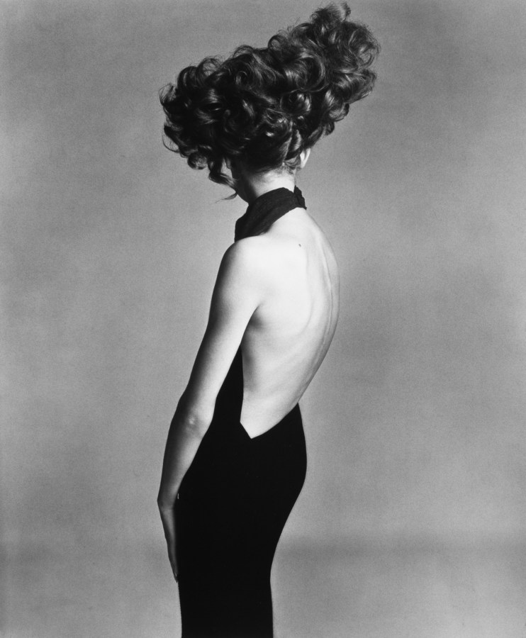 Black and white photograph of a woman in an open back black dress