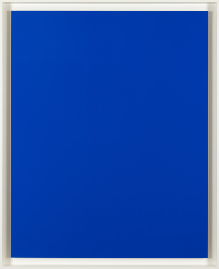 An image of a solid blue colored print in a white frame.
