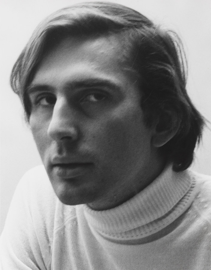 Black and white portrait of Stephen Koch, showing him from the shoulders up and wearing a white turtle neck sweater.
