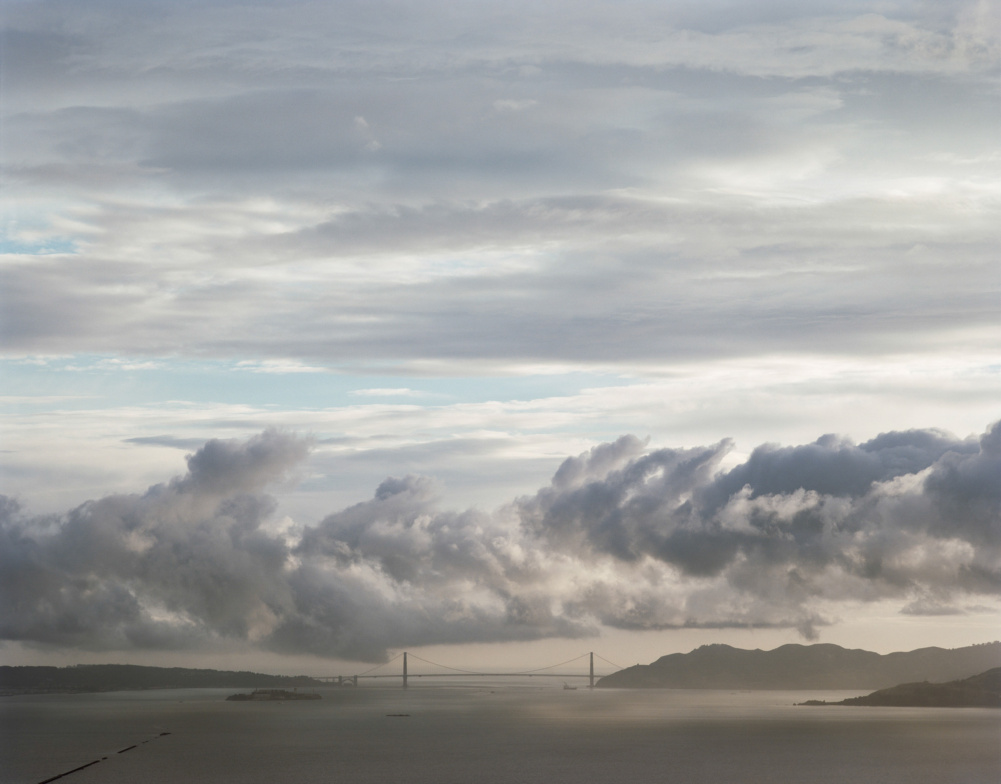 Color photograph of clouds over the Golden Gate Bridge.