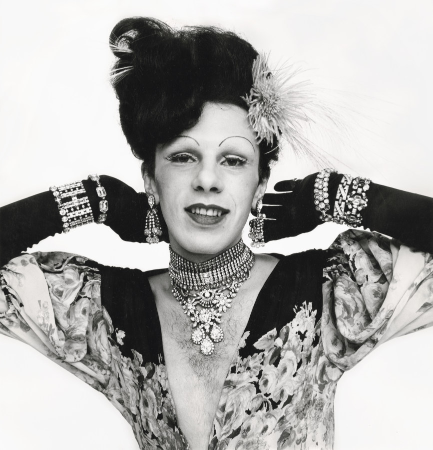 Black and white photograph of female impersonator in jewels and evening wear