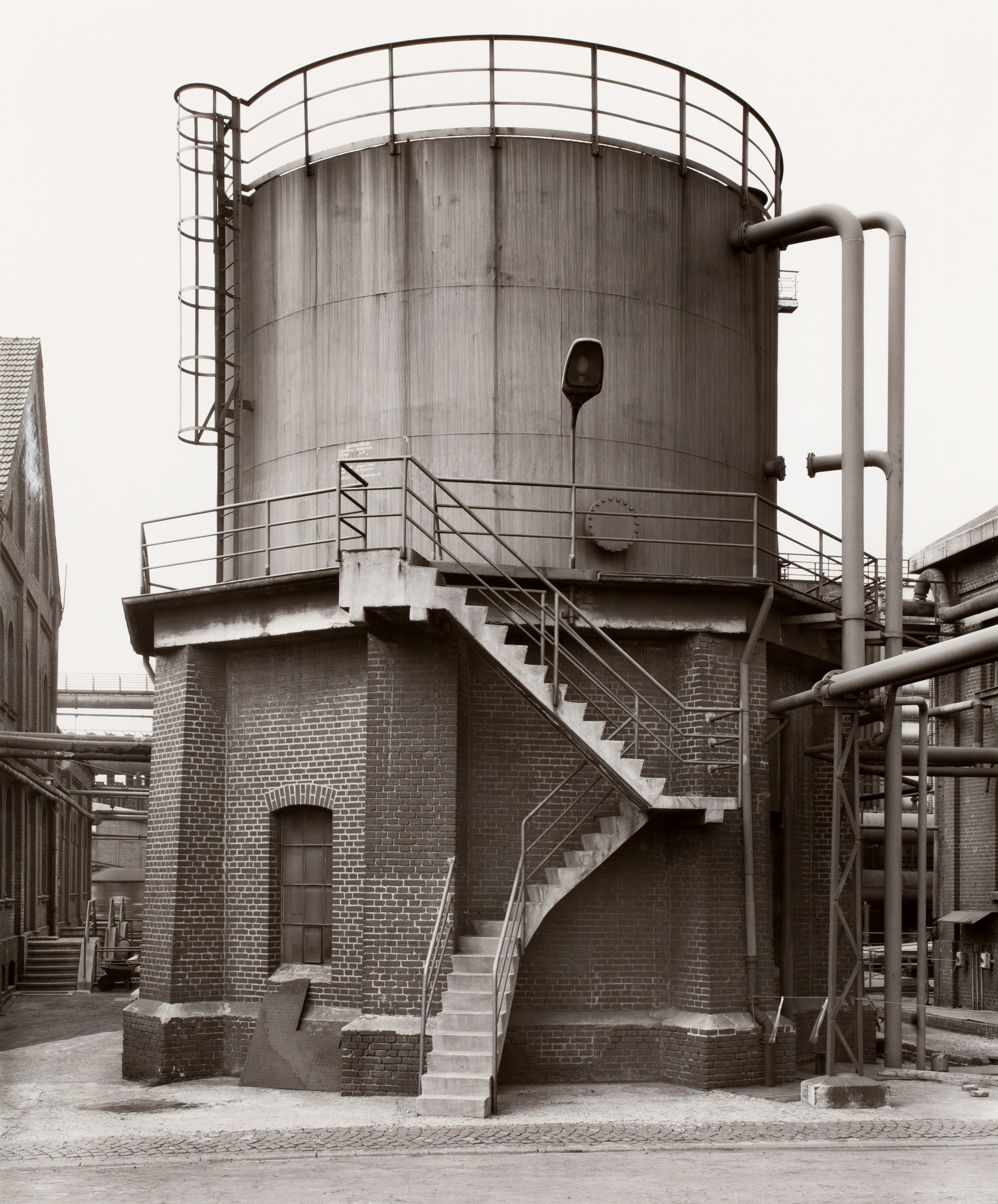 Black and white photograph of a water tower made partially of bricks