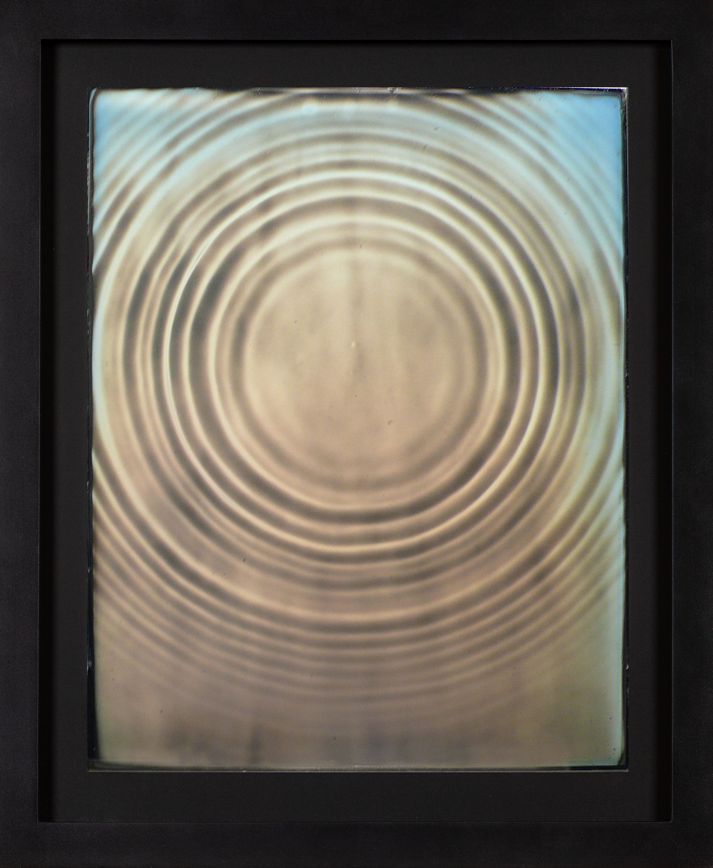 Color image of a daguerreotype depicting the motion of a water droplet framed in black