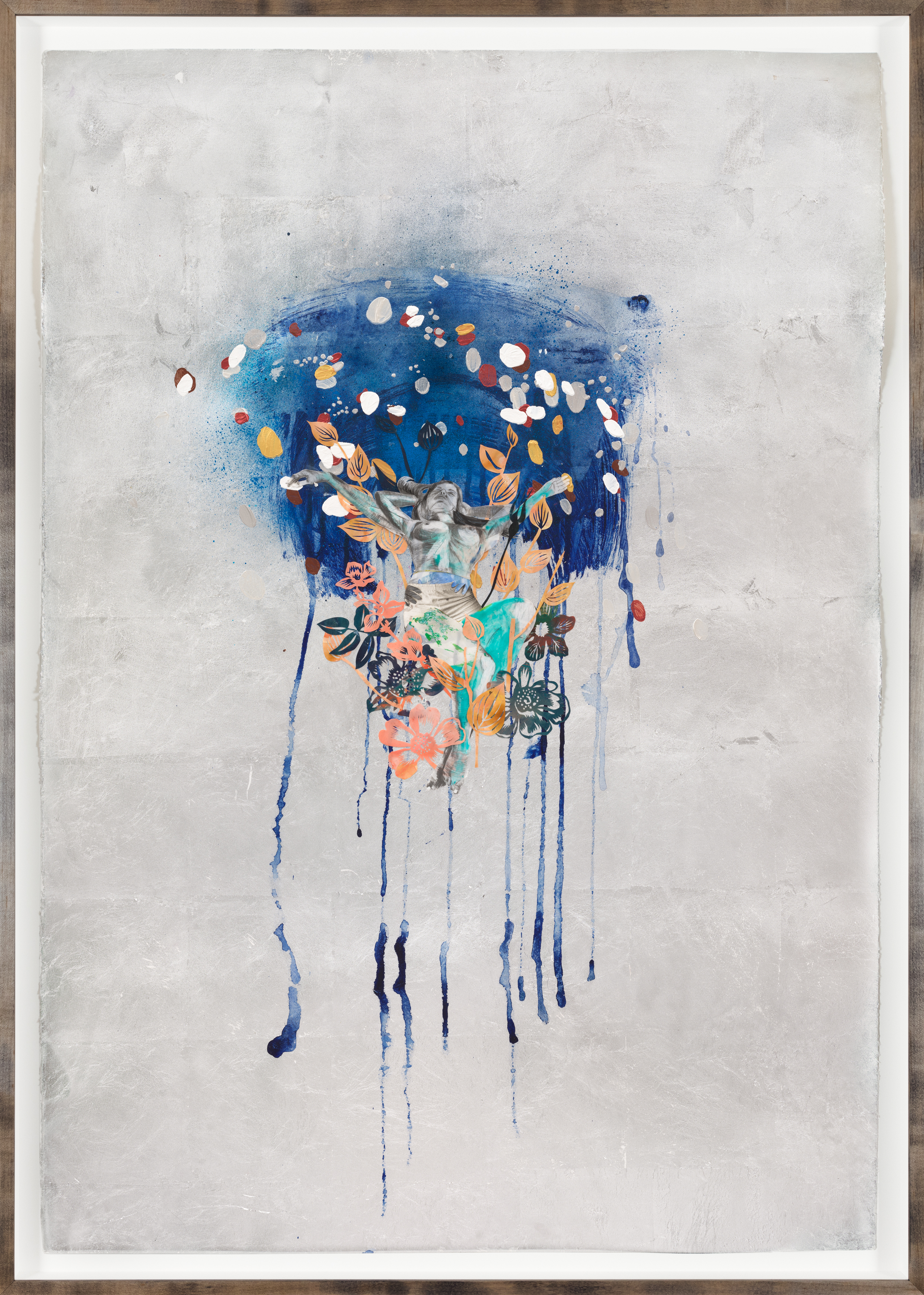 Color image of a mixed media collage with a silver background depicting a semi nude female figure in the middle of flowers against a swatch of blue paint framed in black