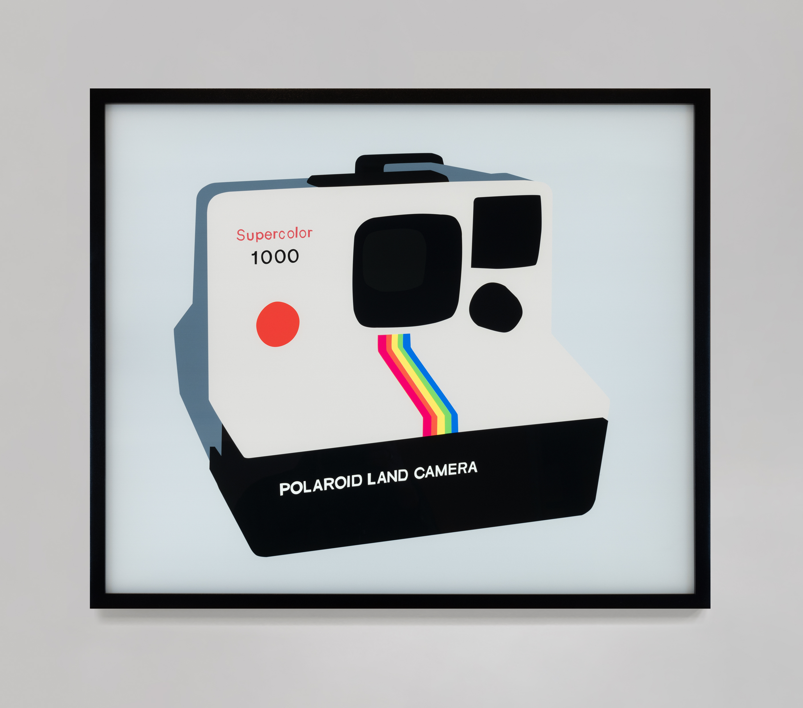 Color image of a color transparency on a lightbox depicting a Polaroid land camera hung on a grey wall