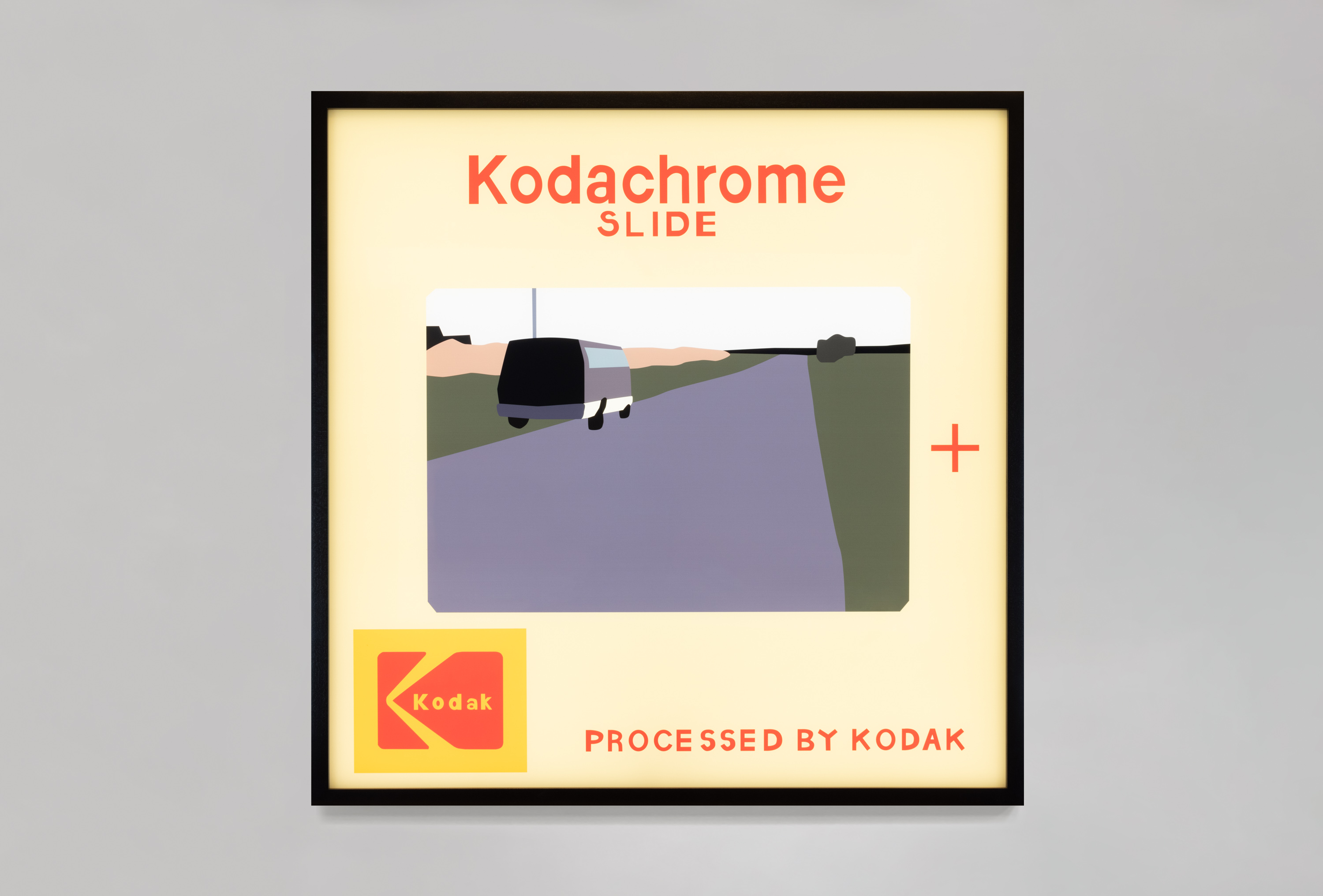 Color image of a color transparency on a light box depicting a Kodachrome color slide of a van driving down a road