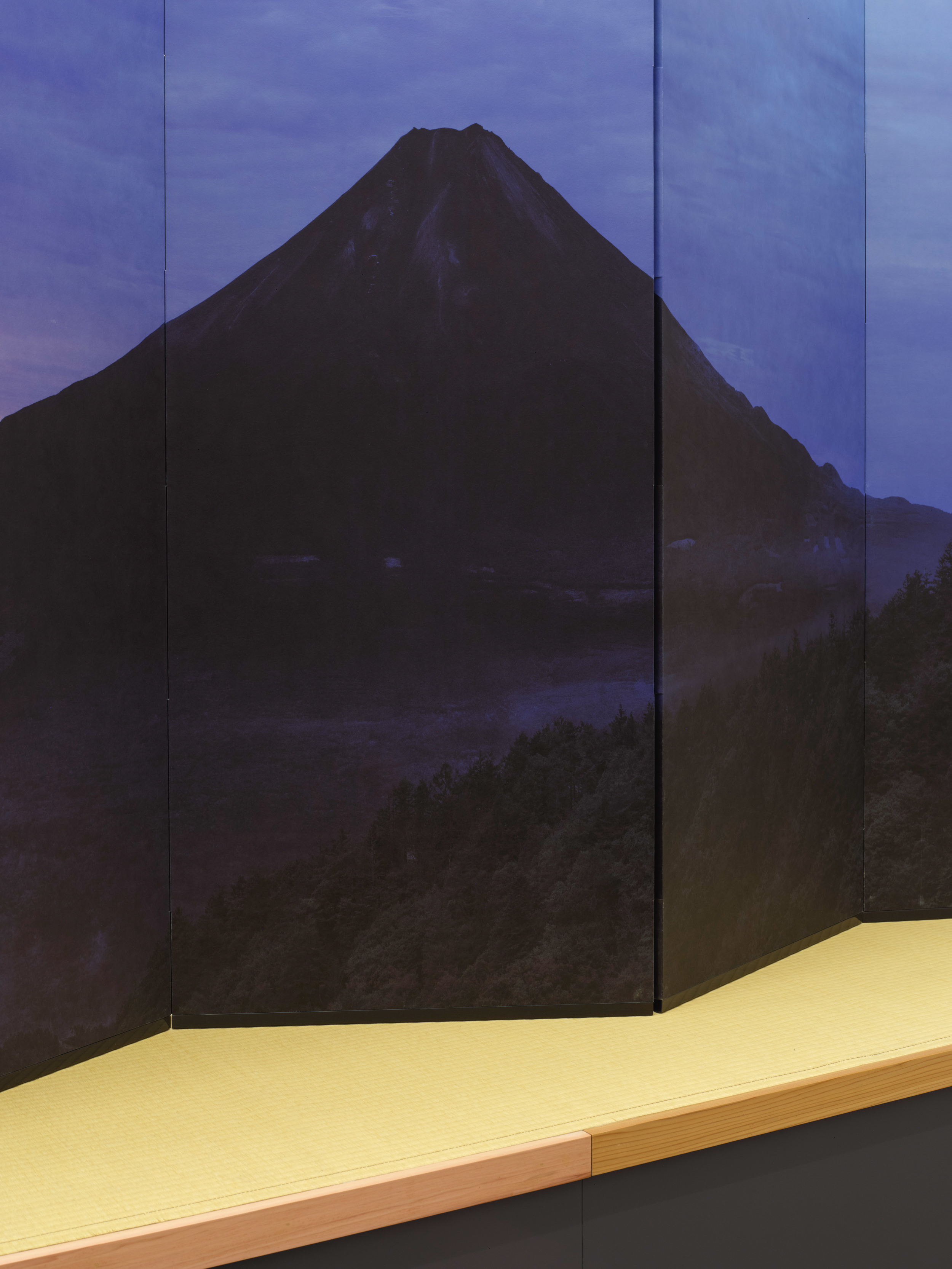 An instillation shot of a folding screen with Mt. Fuji depicted on the screen