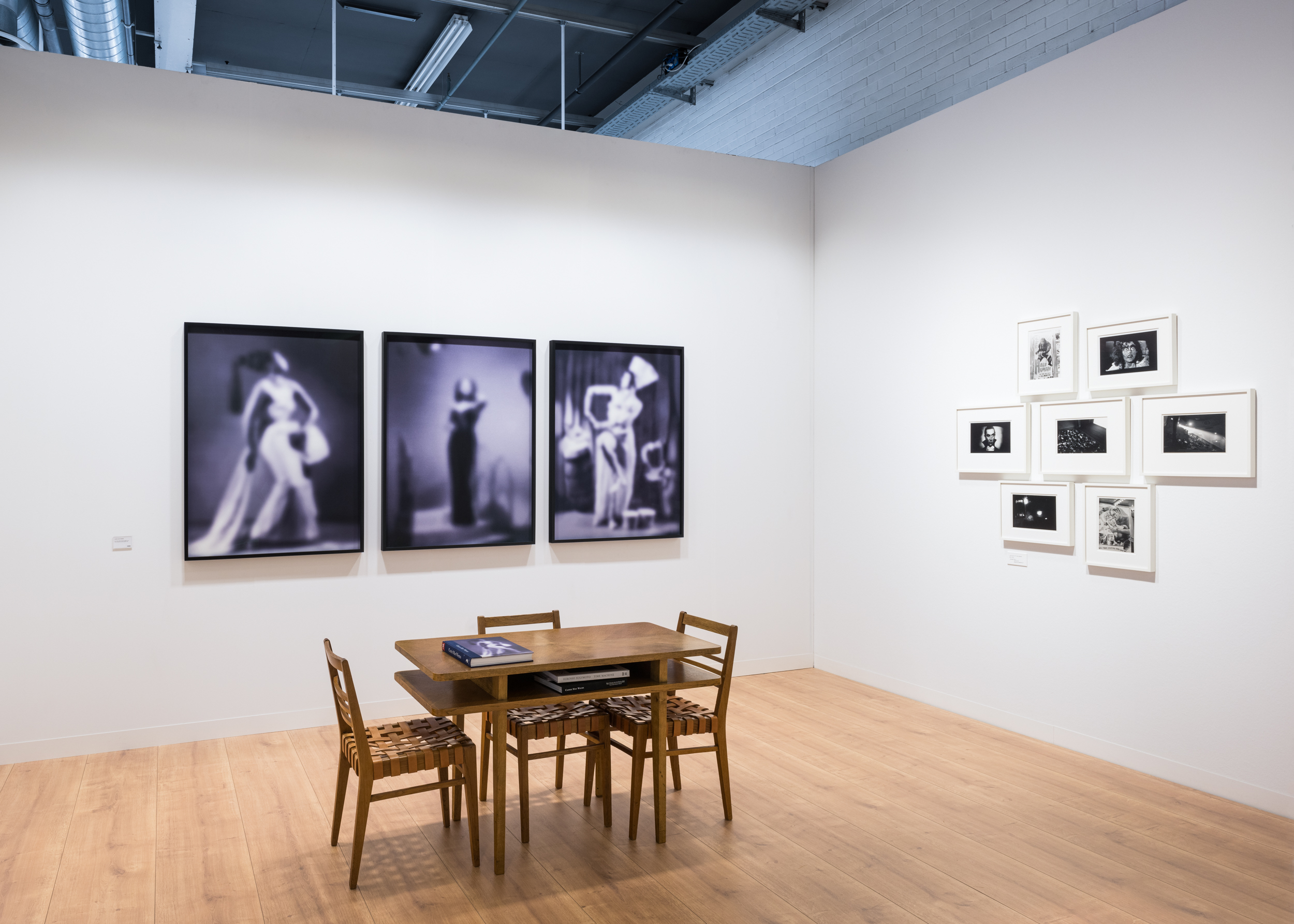 Color image of two suites of framed photographs on white walls