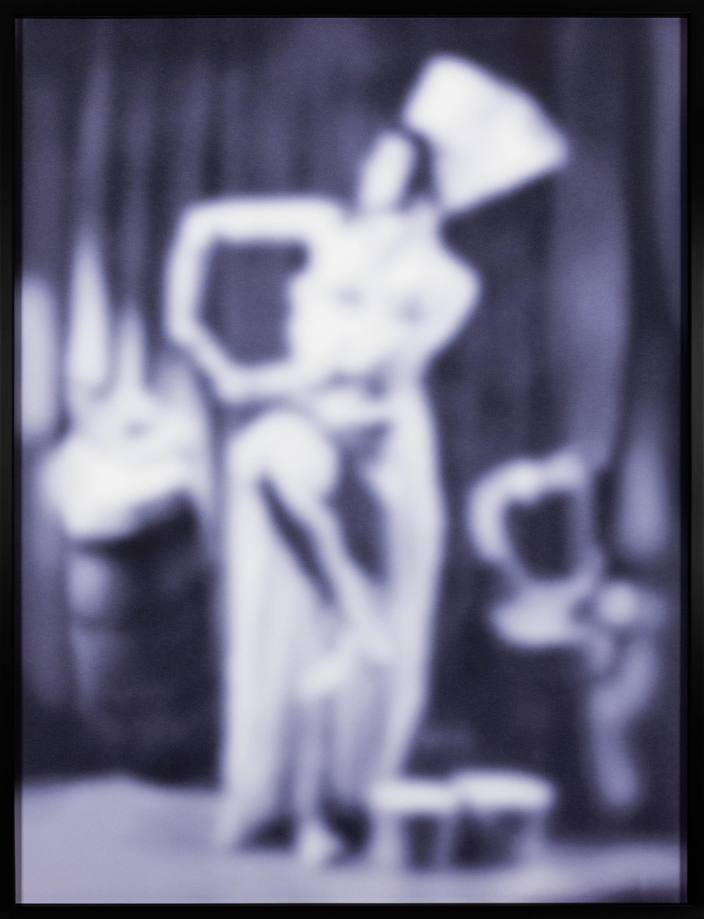 Color image of a purple toned photograph of a performer out of focus framed in black